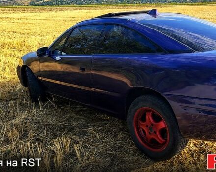 Синій Опель Калібра, об'ємом двигуна 2 л та пробігом 255 тис. км за 2000 $, фото 1 на Automoto.ua