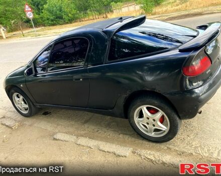 Черный Опель Тигра, объемом двигателя 1.4 л и пробегом 200 тыс. км за 1750 $, фото 1 на Automoto.ua