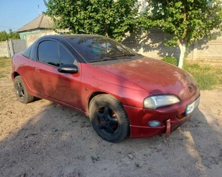 Красный Опель Тигра, объемом двигателя 1.4 л и пробегом 282 тыс. км за 2502 $, фото 1 на Automoto.ua