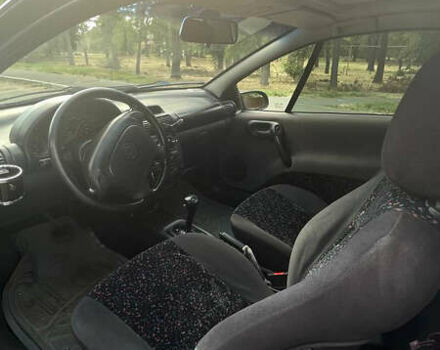 Синий Опель Тигра, объемом двигателя 1.4 л и пробегом 242 тыс. км за 3300 $, фото 6 на Automoto.ua