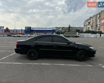 Черный Тойота Камри, объемом двигателя 2.4 л и пробегом 375 тыс. км за 5000 $, фото 1 на Automoto.ua