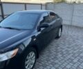 Черный Тойота Камри, объемом двигателя 2.4 л и пробегом 280 тыс. км за 8900 $, фото 1 на Automoto.ua