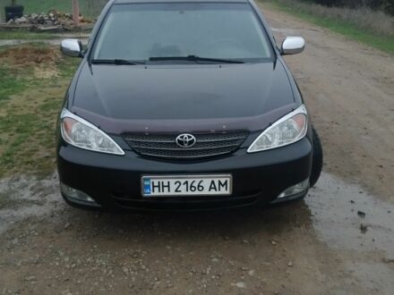 Черный Тойота Камри, объемом двигателя 2.4 л и пробегом 290 тыс. км за 7000 $, фото 1 на Automoto.ua