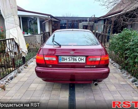 Красный Тойота Карина, объемом двигателя 1.8 л и пробегом 344 тыс. км за 3100 $, фото 1 на Automoto.ua