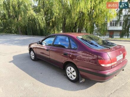 Красный Тойота Carina E, объемом двигателя 1.6 л и пробегом 340 тыс. км за 2400 $, фото 1 на Automoto.ua