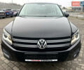 Чорний Фольксваген Тігуан, об'ємом двигуна 2 л та пробігом 165 тис. км за 9499 $, фото 1 на Automoto.ua