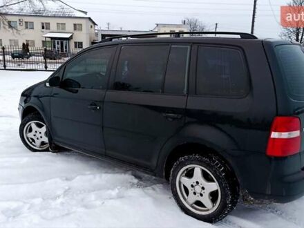 Черный Фольксваген Туран, объемом двигателя 1.6 л и пробегом 300 тыс. км за 4999 $, фото 1 на Automoto.ua