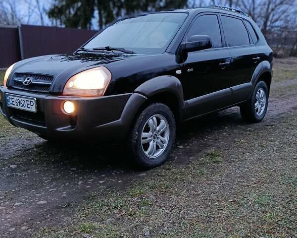 Черный Хендай Туксон, объемом двигателя 1.98 л и пробегом 253 тыс. км за 7600 $, фото 1 на Automoto.ua