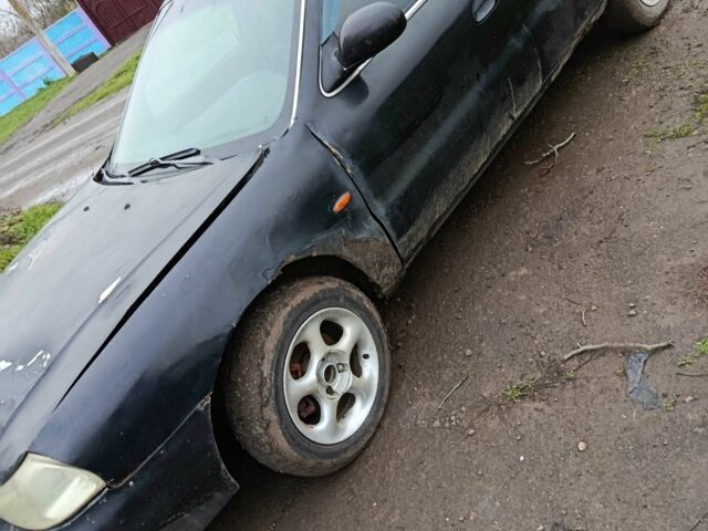 Черный Киа Кларус, объемом двигателя 1.8 л и пробегом 200 тыс. км за 650 $, фото 1 на Automoto.ua