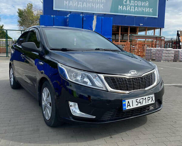 Чорний Кіа Ріо, об'ємом двигуна 1.4 л та пробігом 100 тис. км за 5999 $, фото 1 на Automoto.ua