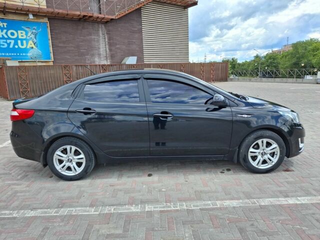 Чорний Кіа Ріо, об'ємом двигуна 1.4 л та пробігом 96 тис. км за 8200 $, фото 1 на Automoto.ua