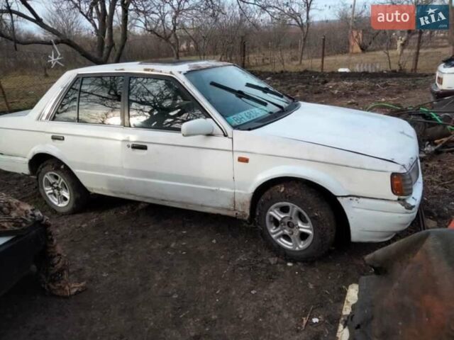 Белый Мазда 323, объемом двигателя 1.5 л и пробегом 100 тыс. км за 558 $, фото 1 на Automoto.ua