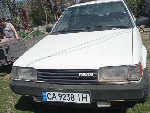 Белый Мазда 323, объемом двигателя 1.3 л и пробегом 350 тыс. км за 457 $, фото 1 на Automoto.ua