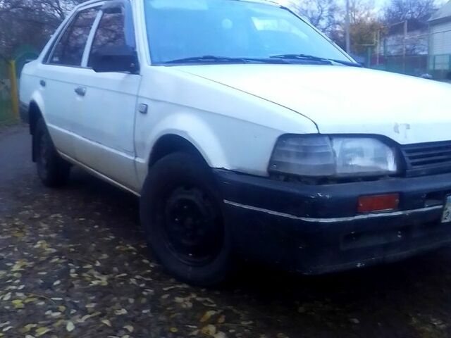 Белый Мазда 323, объемом двигателя 1.3 л и пробегом 100 тыс. км за 750 $, фото 1 на Automoto.ua