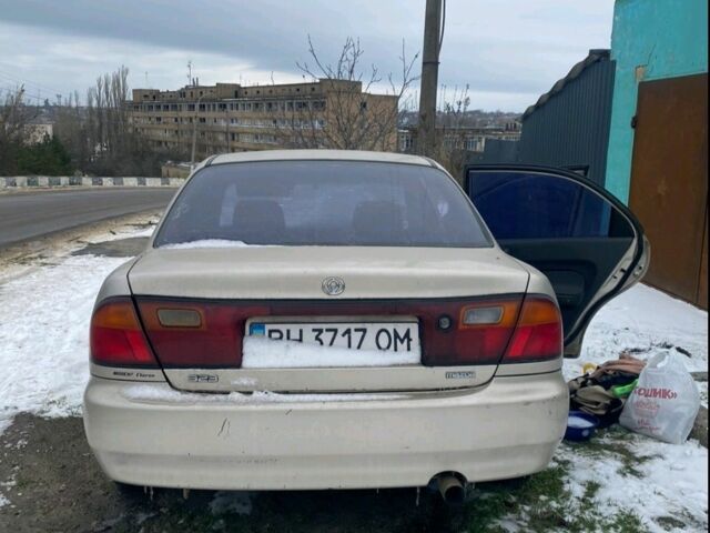 Бежевий Мазда 323, об'ємом двигуна 1.3 л та пробігом 222 тис. км за 1500 $, фото 1 на Automoto.ua