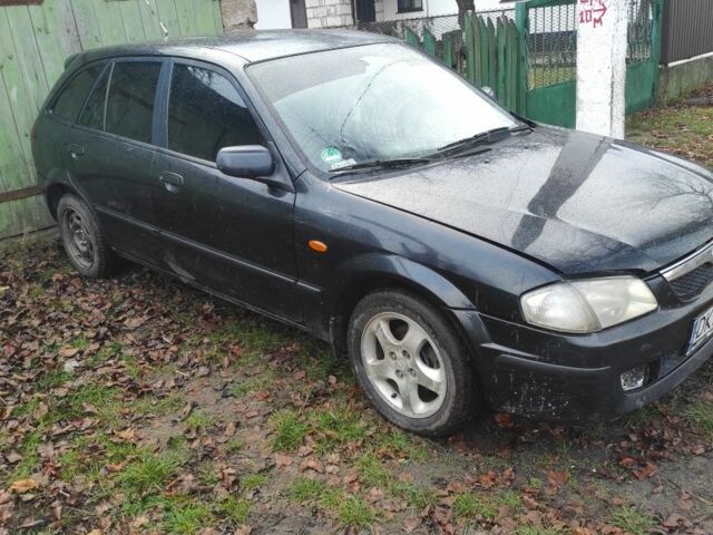 Черный Мазда 323, объемом двигателя 1 л и пробегом 260 тыс. км за 450 $, фото 1 на Automoto.ua