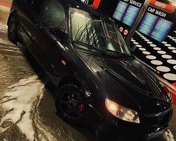 Черный Мазда 323, объемом двигателя 1.6 л и пробегом 250 тыс. км за 2500 $, фото 1 на Automoto.ua
