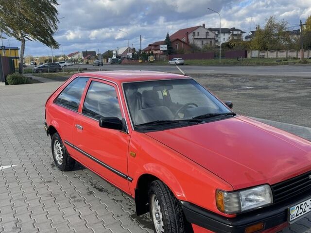 Красный Мазда 323, объемом двигателя 1.3 л и пробегом 225 тыс. км за 650 $, фото 1 на Automoto.ua