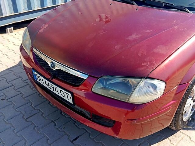 Червоний Мазда 323, об'ємом двигуна 1.5 л та пробігом 260 тис. км за 1500 $, фото 1 на Automoto.ua