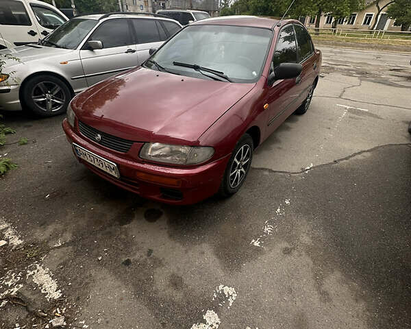 Красный Мазда 323, объемом двигателя 1.5 л и пробегом 295 тыс. км за 2500 $, фото 1 на Automoto.ua