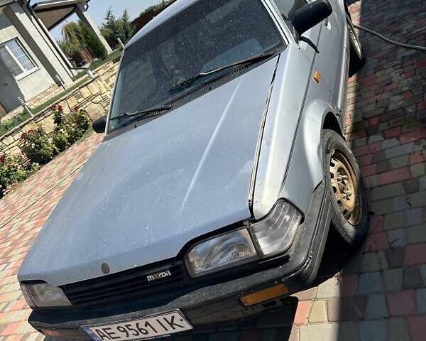 Серый Мазда 323, объемом двигателя 1.3 л и пробегом 300 тыс. км за 826 $, фото 1 на Automoto.ua