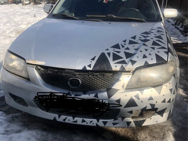 Серый Мазда 323, объемом двигателя 2 л и пробегом 250 тыс. км за 1000 $, фото 1 на Automoto.ua