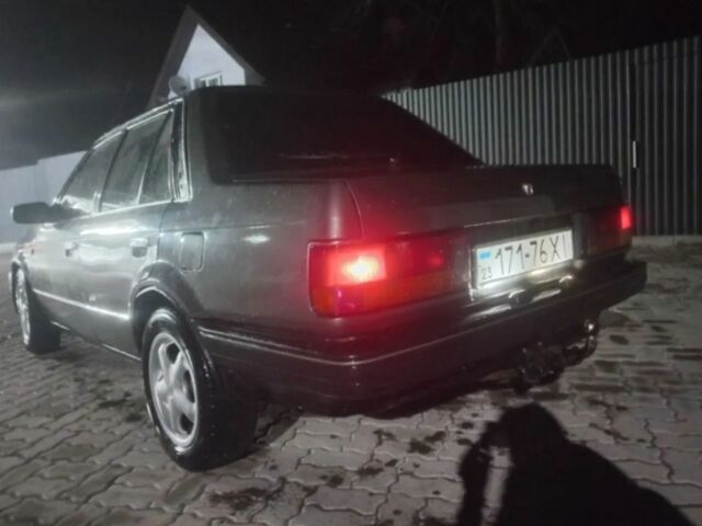 Серый Мазда 323, объемом двигателя 1 л и пробегом 180 тыс. км за 559 $, фото 1 на Automoto.ua