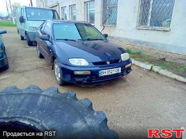 Синій Мазда 323, об'ємом двигуна 1.3 л та пробігом 330 тис. км за 1250 $, фото 1 на Automoto.ua
