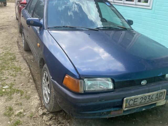 Синій Мазда 323, об'ємом двигуна 1 л та пробігом 427 тис. км за 720 $, фото 1 на Automoto.ua