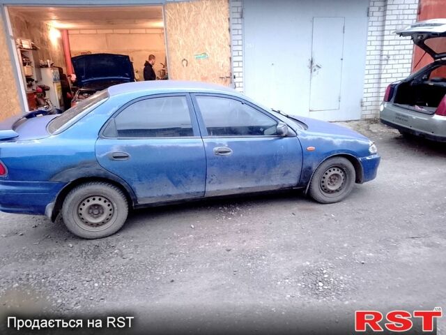 Синий Мазда 323, объемом двигателя 1.5 л и пробегом 250 тыс. км за 800 $, фото 1 на Automoto.ua