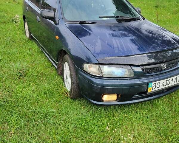 Синій Мазда 323, об'ємом двигуна 1.5 л та пробігом 345 тис. км за 1000 $, фото 1 на Automoto.ua