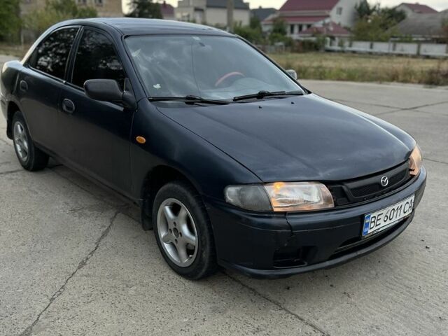 Синий Мазда 323, объемом двигателя 1.5 л и пробегом 200 тыс. км за 1250 $, фото 1 на Automoto.ua