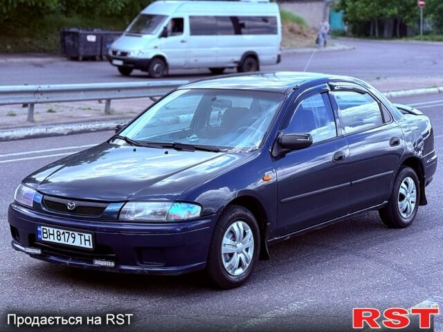 Синий Мазда 323, объемом двигателя 1.5 л и пробегом 300 тыс. км за 1500 $, фото 1 на Automoto.ua