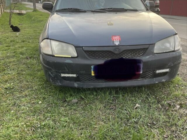 Синий Мазда 323, объемом двигателя 2 л и пробегом 300 тыс. км за 1100 $, фото 1 на Automoto.ua