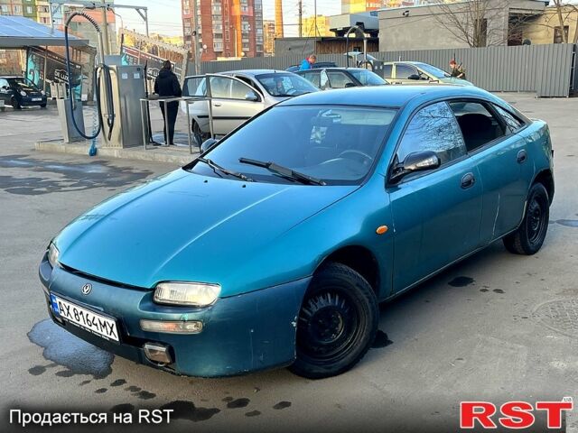 Зеленый Мазда 323, объемом двигателя 1.5 л и пробегом 215 тыс. км за 900 $, фото 1 на Automoto.ua