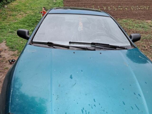 Зеленый Мазда 323, объемом двигателя 1.5 л и пробегом 250 тыс. км за 1016 $, фото 1 на Automoto.ua