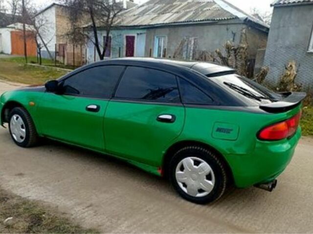Зеленый Мазда 323, объемом двигателя 10 л и пробегом 100 тыс. км за 960 $, фото 1 на Automoto.ua