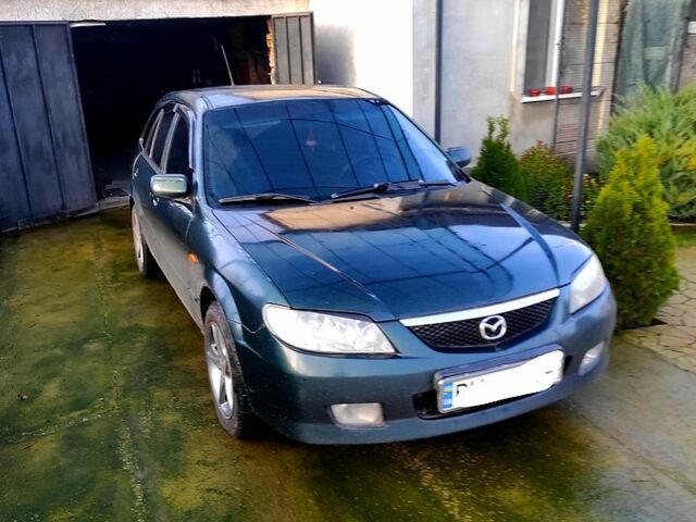 Зеленый Мазда 323, объемом двигателя 2 л и пробегом 210 тыс. км за 3000 $, фото 1 на Automoto.ua