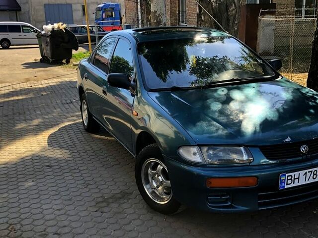 Зеленый Мазда 323, объемом двигателя 1.3 л и пробегом 211 тыс. км за 2700 $, фото 1 на Automoto.ua