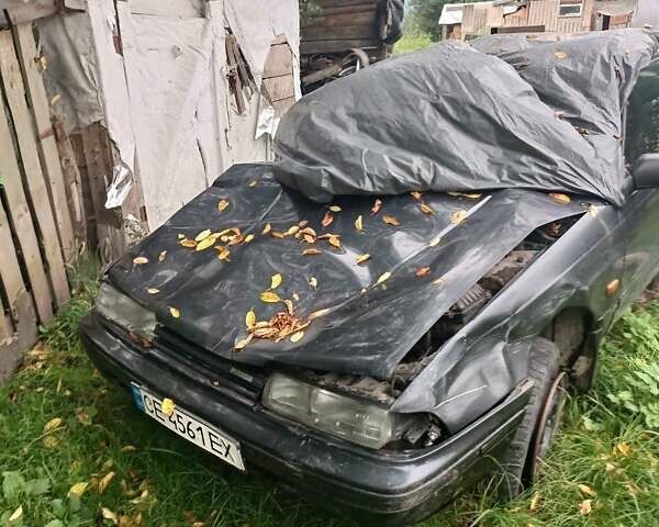 Черный Мазда 626, объемом двигателя 2.2 л и пробегом 400 тыс. км за 500 $, фото 1 на Automoto.ua