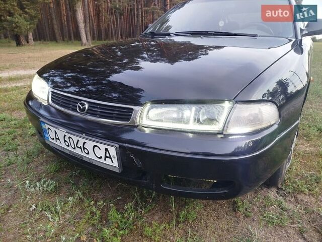 Черный Мазда 626, объемом двигателя 1.8 л и пробегом 452 тыс. км за 1800 $, фото 1 на Automoto.ua