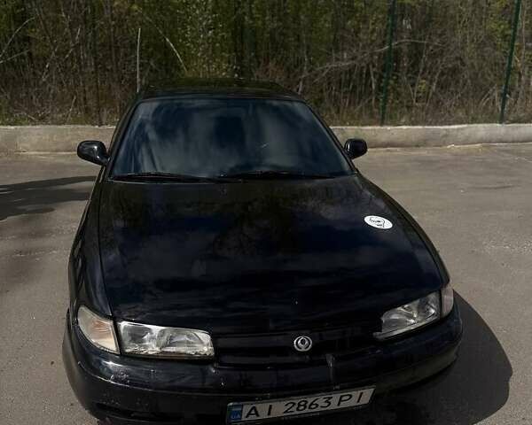 Черный Мазда 626, объемом двигателя 2.5 л и пробегом 380 тыс. км за 900 $, фото 1 на Automoto.ua