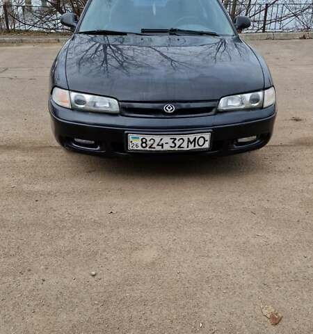Черный Мазда 626, объемом двигателя 2.5 л и пробегом 380 тыс. км за 1500 $, фото 1 на Automoto.ua