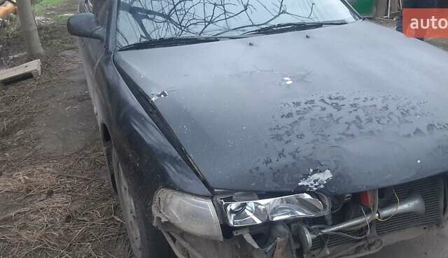 Черный Мазда 626, объемом двигателя 1.8 л и пробегом 520 тыс. км за 1900 $, фото 1 на Automoto.ua