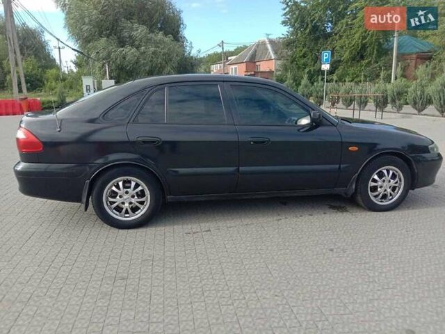 Черный Мазда 626, объемом двигателя 1.8 л и пробегом 316 тыс. км за 2700 $, фото 1 на Automoto.ua
