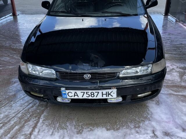 Черный Мазда 626, объемом двигателя 1.8 л и пробегом 250 тыс. км за 793 $, фото 1 на Automoto.ua