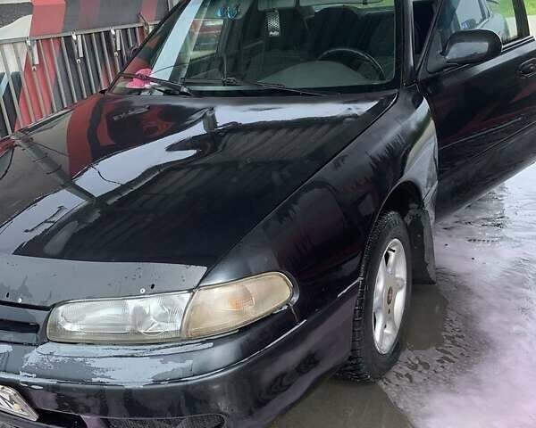 Черный Мазда 626, объемом двигателя 2 л и пробегом 345 тыс. км за 1650 $, фото 1 на Automoto.ua