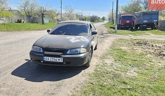 Черный Мазда 626, объемом двигателя 2 л и пробегом 253 тыс. км за 2600 $, фото 1 на Automoto.ua