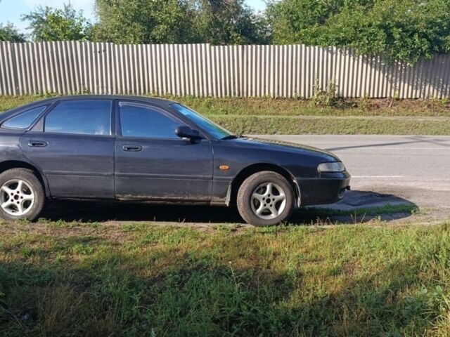 Черный Мазда 626, объемом двигателя 1.8 л и пробегом 500 тыс. км за 1800 $, фото 1 на Automoto.ua