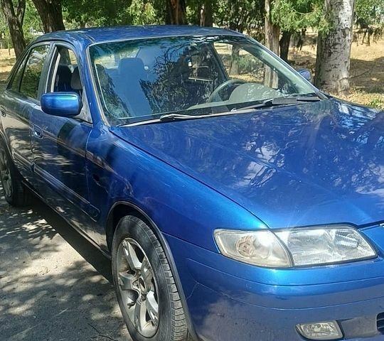 Синий Мазда 626, объемом двигателя 1.7 л и пробегом 326 тыс. км за 1900 $, фото 1 на Automoto.ua